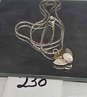 Necklace coiled on surface showing pendant design