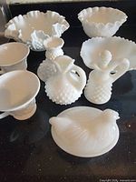 Group view of all six milk glass pieces on countertop