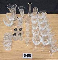 Full group shot of all Waterford crystal pieces including stemware stacks, vases, napkin rings and shakers