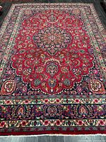 Full view of entire rug showing central medallion and borders