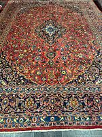 Full view of Kashan Persian rug showing field, medallion, and borders