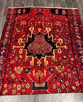 Full view of handmade Persian wool rug showing size and overall geometric design