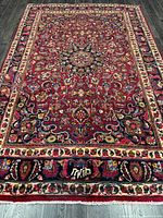 Full view of rug showing design, borders, fringe