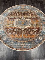 Full view of round Turkish rug showing complete pattern and colors