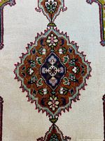 Close-up of central floral medallion on cream field