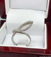 Front view of sterling silver illusion-stone twist ring in box