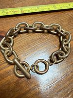 Bracelet coiled to show thickness of links and clasp