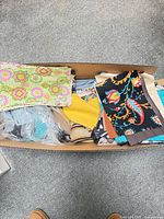 Box with assorted colorful fabric pieces and scraps