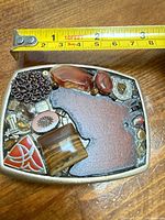 Top view of handmade belt buckle with tape measure showing width