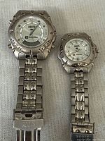 Two Roots watches side by side showing size difference, dials and bracelets visible