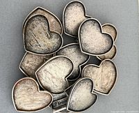Stack of 12 heart-shaped belt buckle blanks front view