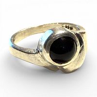 Front view of sterling silver ring showing round black stone in bezel setting