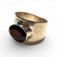 Front view showing red stone and wide sterling band