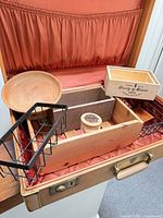 Open suitcase showing orange lining and contents