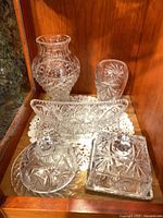 all eight crystal pieces grouped in cabinet