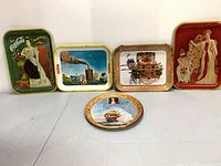 Group shot of five Coca-Cola trays showing all designs and shapes