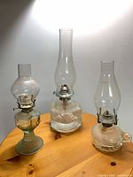all three glass oil lamps on table