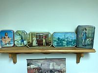 All five tins lined on shelf