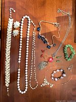 All jewelry pieces laid out on wood surface