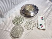overview of 4 glass flower frogs, silverplate bowl with glass insert, porcelain tray