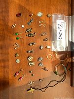 Overview of jewelry laid out on wood surface