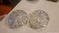 Two matching clear pressed glass dishes with lids