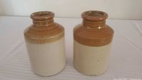 Both two-tone stoneware jars side by side