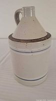 Front view of jug showing funnel lid, handle and blue banding