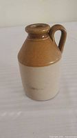 Front view of small two-tone stoneware jug