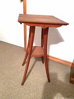 Three-quarter view of table showing legs and lower shelf