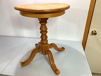 Full view of solid pine round pedestal side table with tripod base