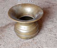 Angled view of brass spittoon showing overall form and patina