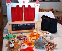 Theater, tote bag, and array of puppets displayed on table