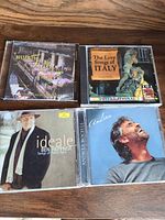 Front view of four CD cases showing cover art and titles