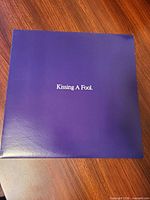 Front of purple outer sleeve displaying title text