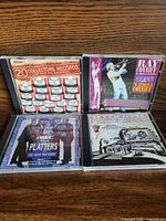 Front view of four CDs showing titles and cover art