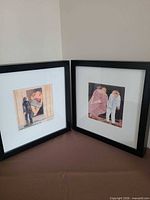 Both framed prints standing side by side