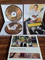 Front view of open Haydn disc, Yo-Yo Ma cover, Oistrakh disc, Pink Martini digipak