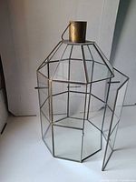 Lantern with door open showing brass frame and glass panels