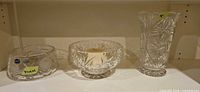 Three Bohemia crystal pieces on shelf: low bowl, footed bowl, vase