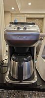Front view showing Breville coffee maker with stainless thermal carafe inserted