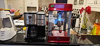 Group shot of Cuisinart coffee maker, red popcorn machine, and white appliance on countertop