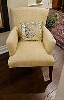 Front view of Fairfield beige armchair with gold sequin pillow