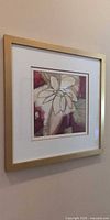 Full view of framed floral print on wall