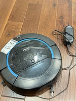 Top view of iRobot Scooba 450 robot with charger cord visible