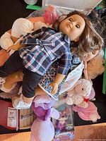 Stacked view showing multiple dolls, plush toys and boxed Lil' Gleemerz
