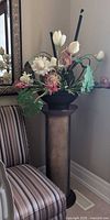Round wood pedestal with faux floral arrangement