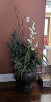 Full view of tall faux arrangement in urn planter