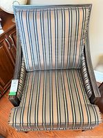 Front view of striped upholstered armchair showing seat and back cushions