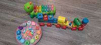 Overall view of xylophone, wooden train and clock puzzle